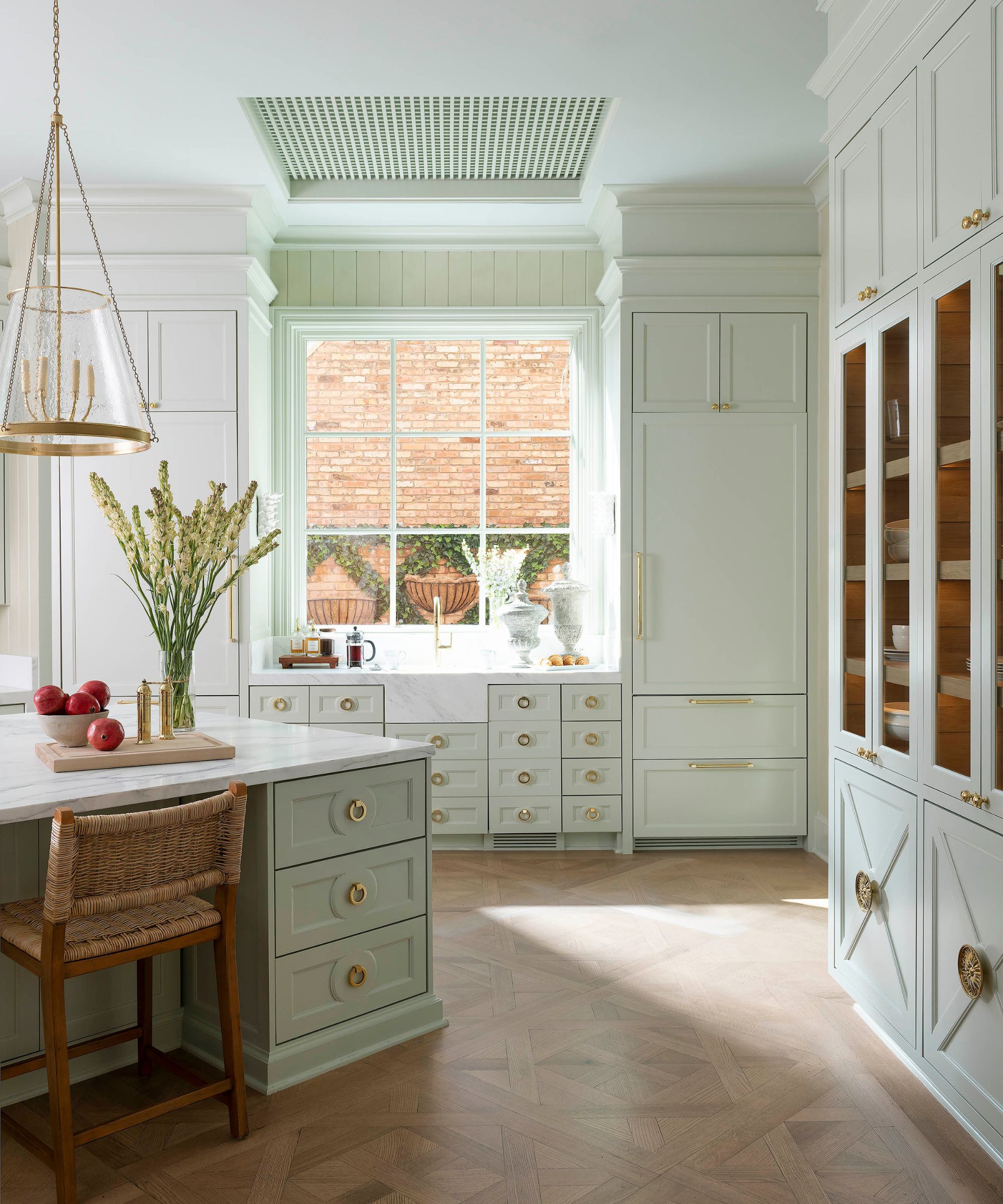 light and airy kitchen with wood flooring and light pistachio cabinets