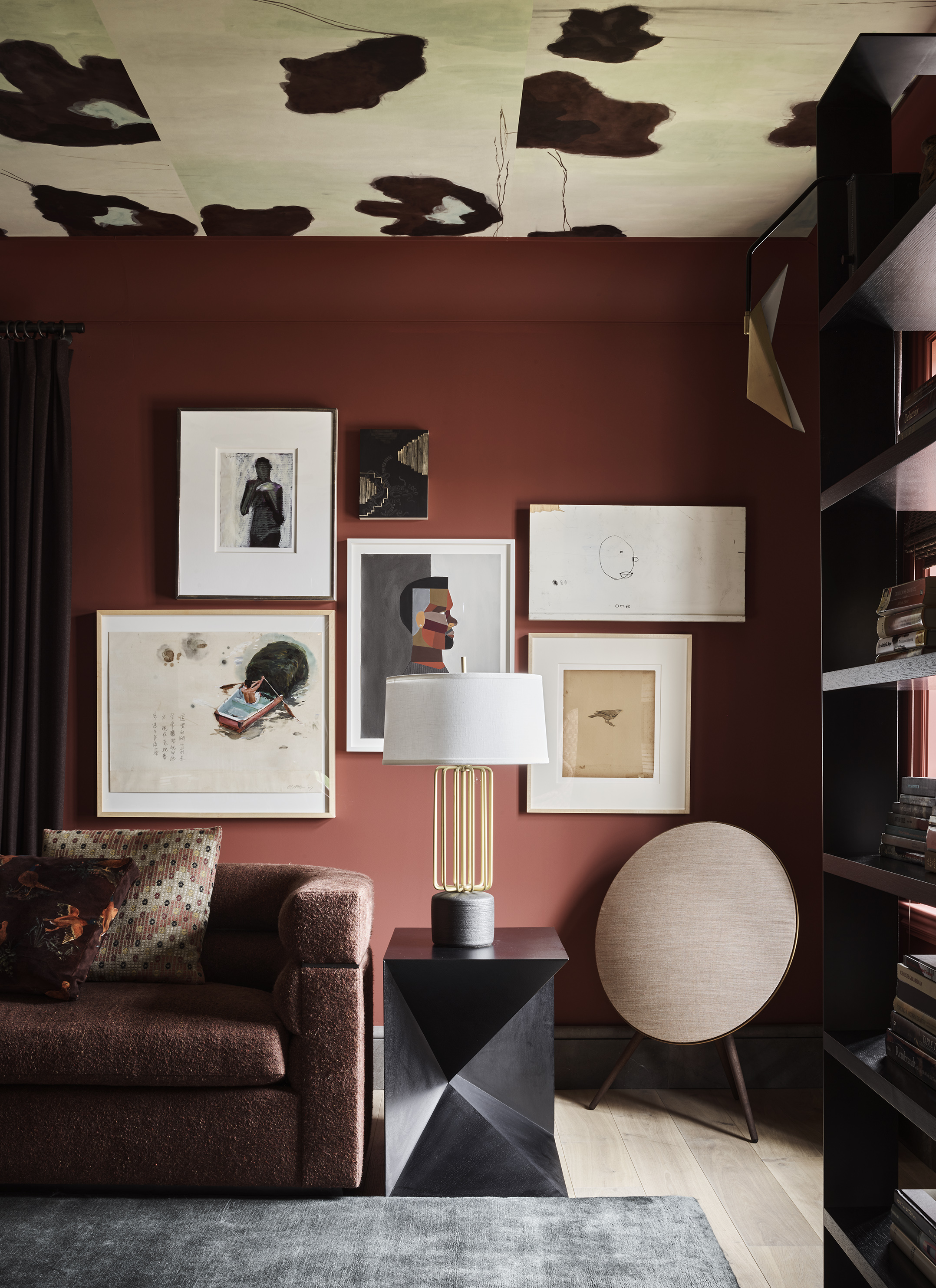 A contemporary living room filled with eclectic furniture, accessories, and wall art