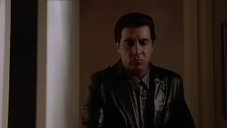 Silvio Dante looking serious in a leather coat and looking down in The Sopranos