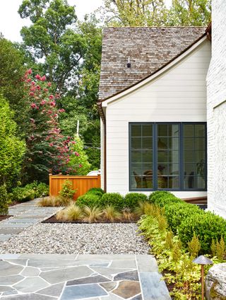 a side yard with gravel and paving