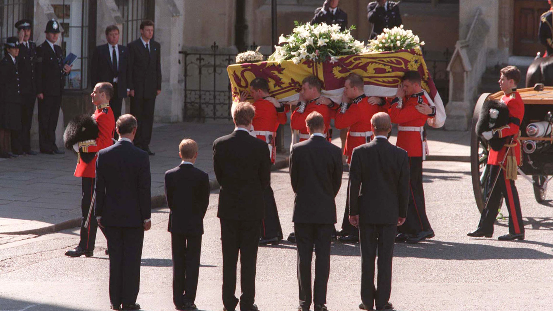 Men carrying Princess Diana's coffin with Prince Harry, Prince William, King Charles, Earl Spencer and Prince Philip facing it with their backs to the camera