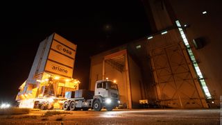 The James Webb Space Telescope sits inside a protective container during a short trip into the final assembly building.