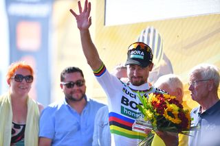 Peter Sagan (Bora-Hansgrohe) waves to the crowd from the podium after winning stage 2