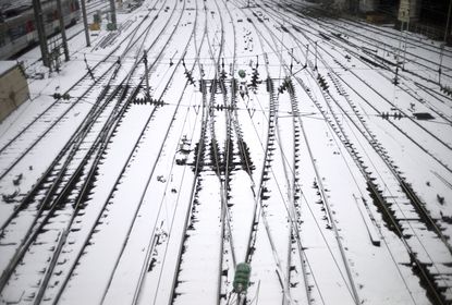 A picture taken on March 12, 2013 shows snow-covered tracks near the Saint Lazare railway station in Paris. More than 68,000 homes were without electricity in France and hundreds of people we