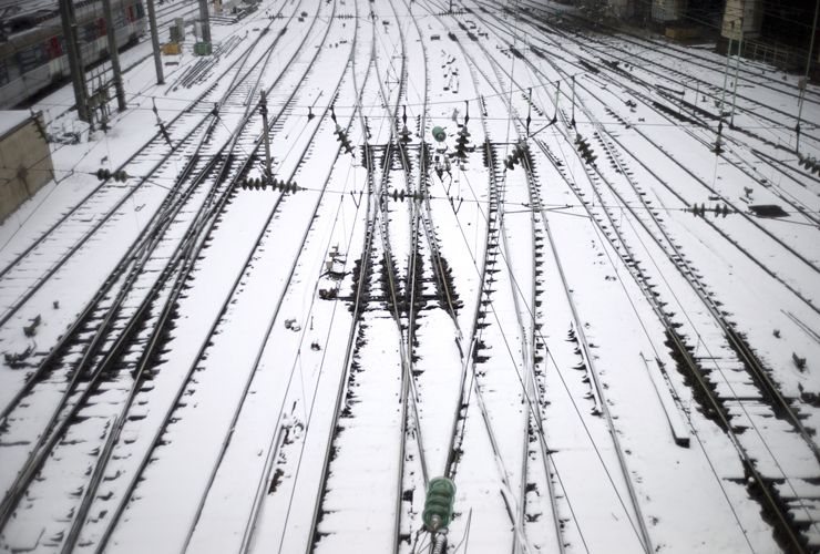 A picture taken on March 12, 2013 shows snow-covered tracks near the Saint Lazare railway station in Paris. More than 68,000 homes were without electricity in France and hundreds of people we