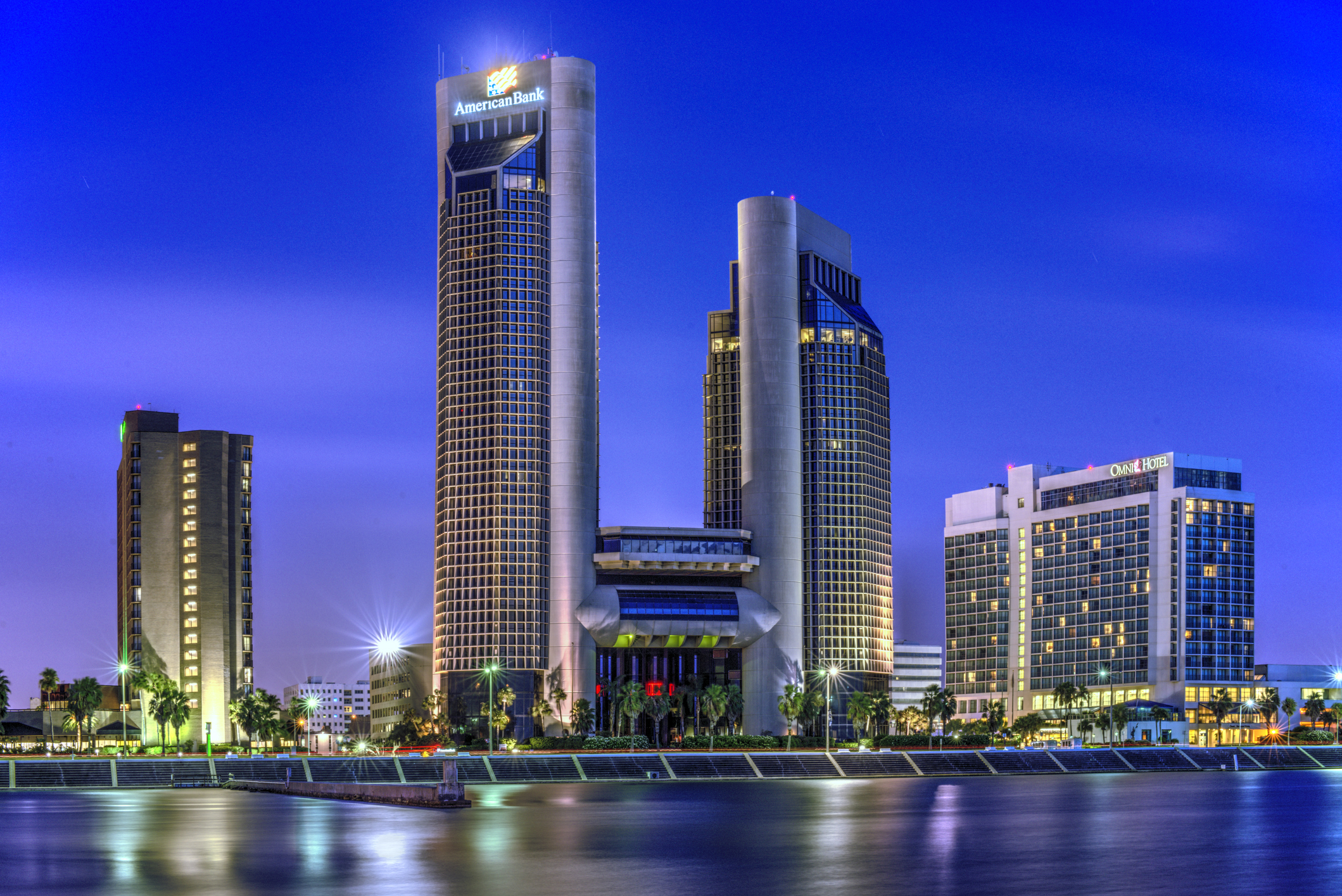 The skyline of Corpus Christi Texas shot at dawn from offshore. Beautiful blue colors and reflections in the calm bay.