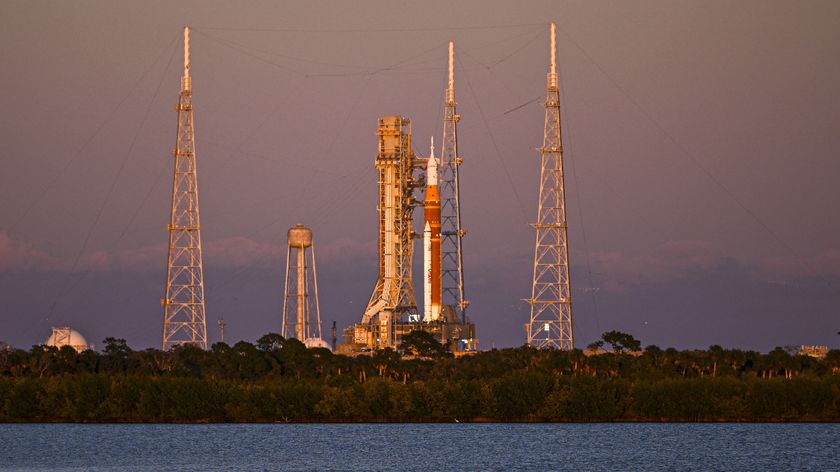 A photo of the Artemis II rocket sitting on a launchpad at Kennedy Space Center in Cape Canaveral, Florida, at sunset. 