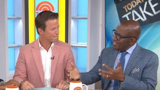 Al Roker and Billy Bush talk while sitting at a desk on The Today Show.