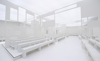 A white room with white benches and flooring.
