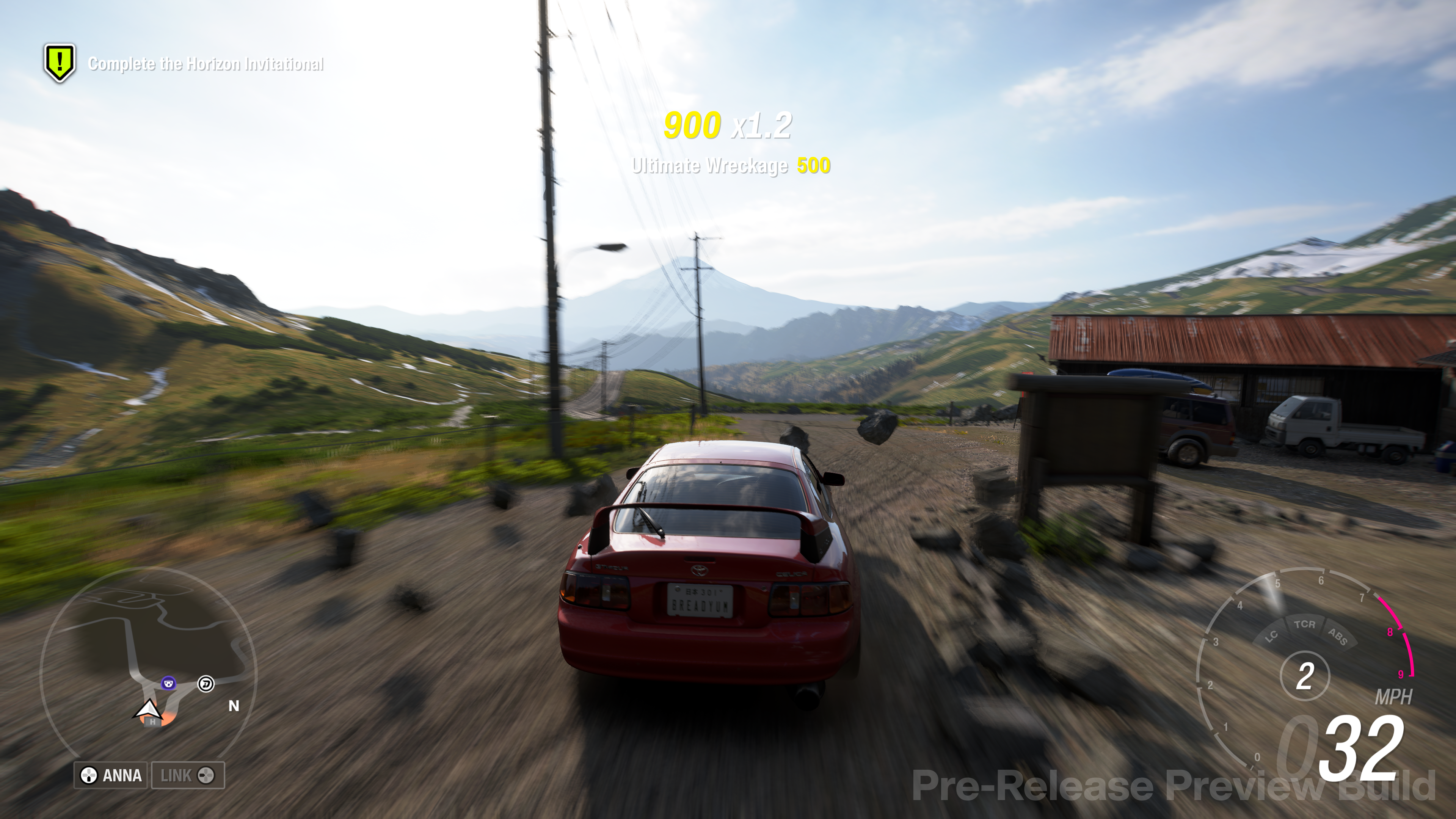 A car on a hill overlooking a view with Mount Fuji in the background