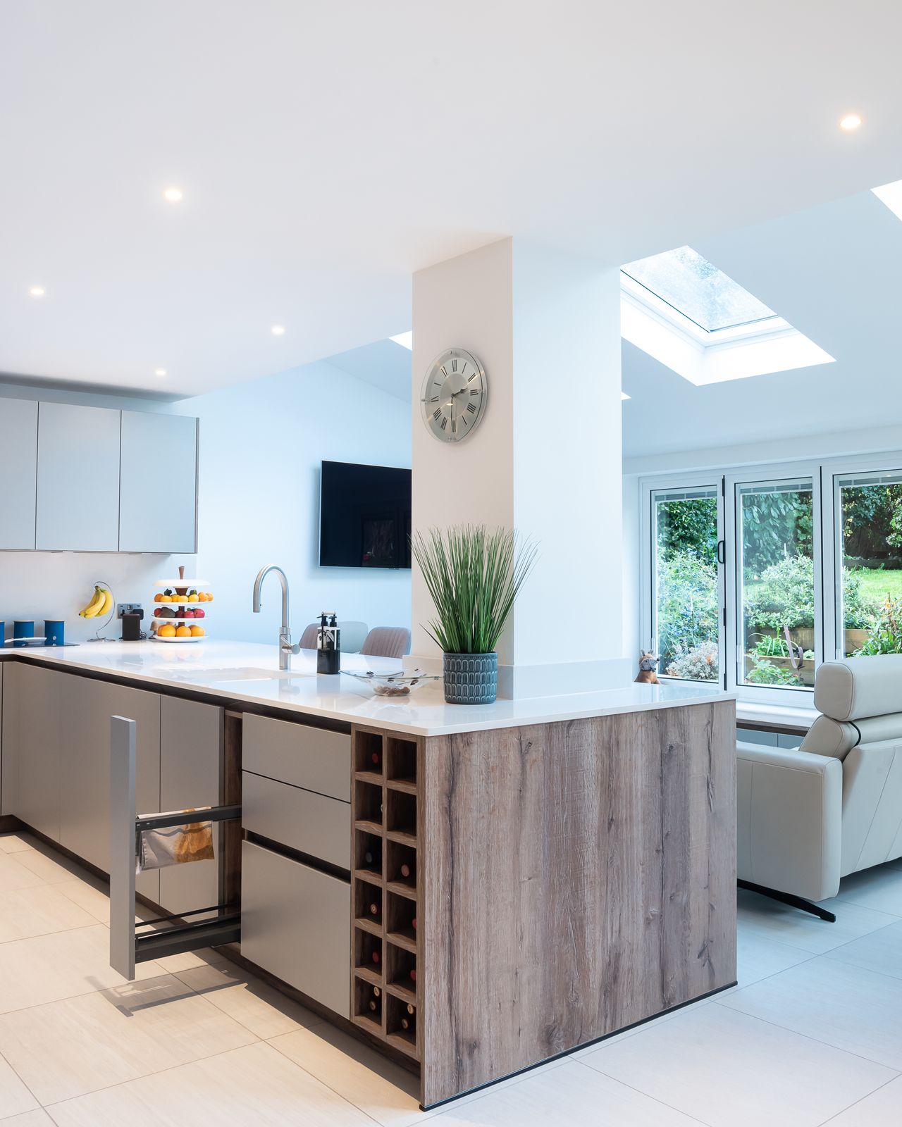 A kitchen with a peninsula that offers storage, cleaning and a place to chop veggies