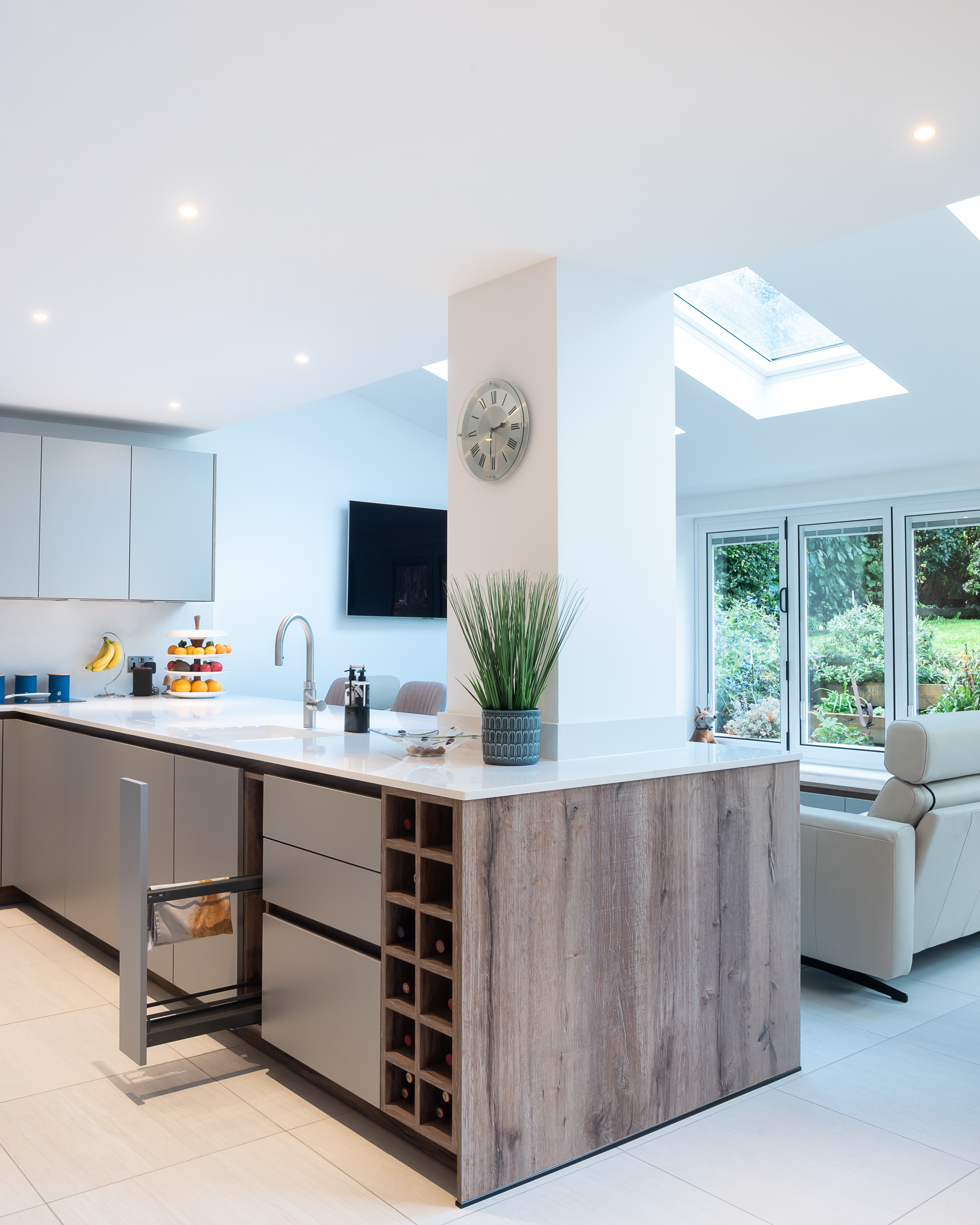 A kitchen with a peninsula that offers storage, cleaning and a place to chop veggies 