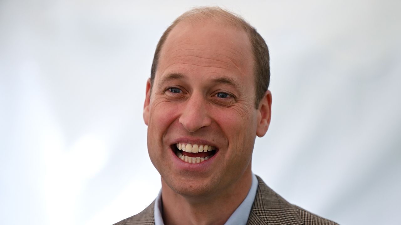 Prince William hints at dreamy destination for family trip. Seen here he talks with workers from across the construction industry