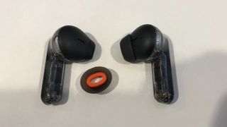 JBL Tune Flex earbuds with open-ear tip on left, closed on the right bud