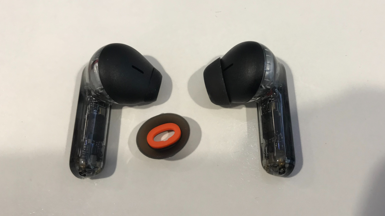 JBL Tune Flex earbuds with open-ear tip on left, closed on the right bud