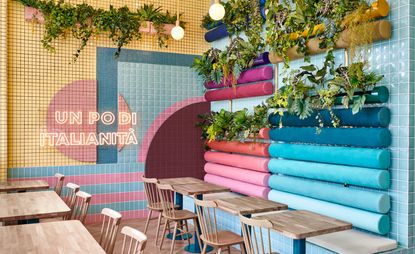 Pastel-hued walls accompanied by wooden tables and chairs at Piada in Lyon, France