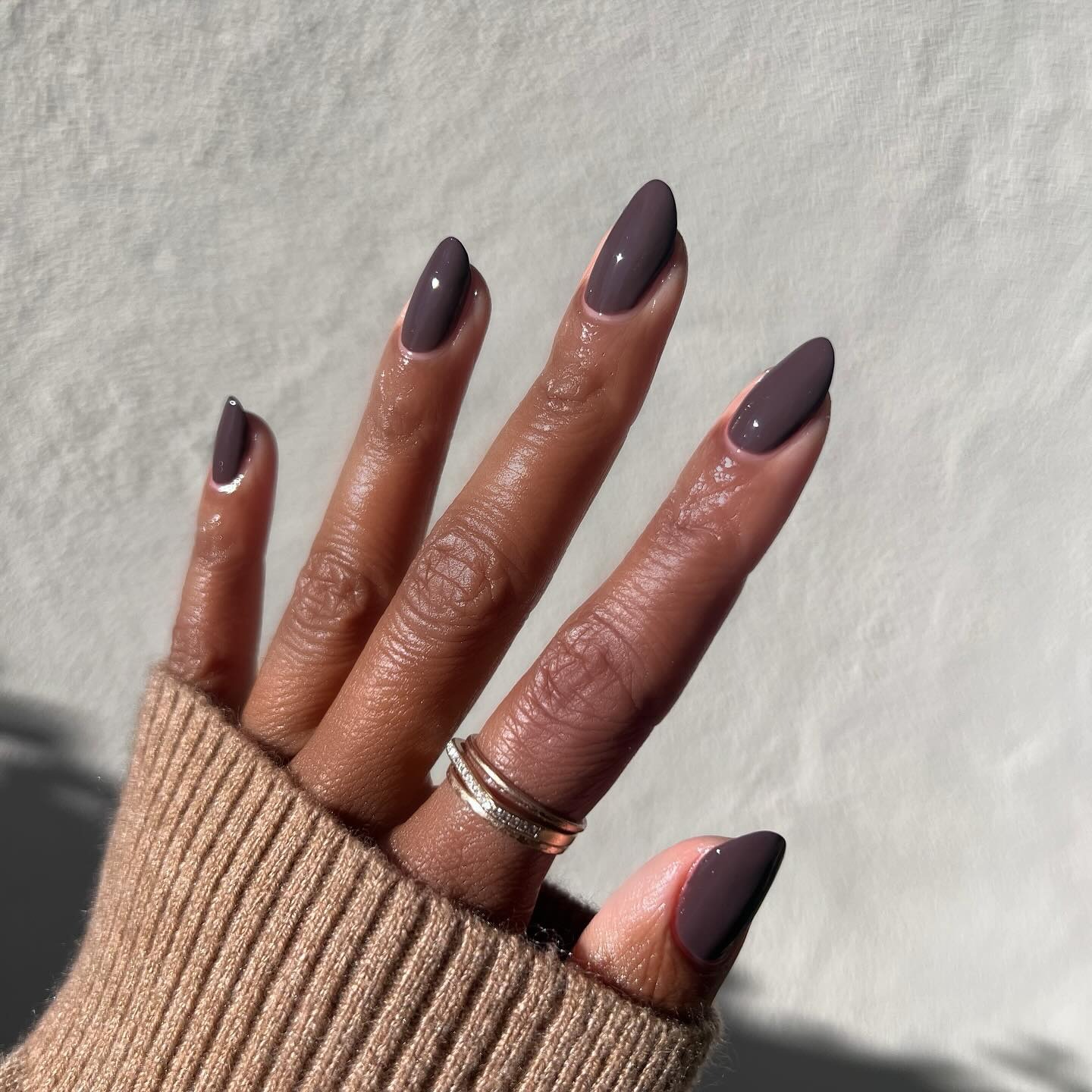 Long almond nails with dark chocolate brown polish