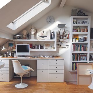 attic study room and mac on table and books shelves