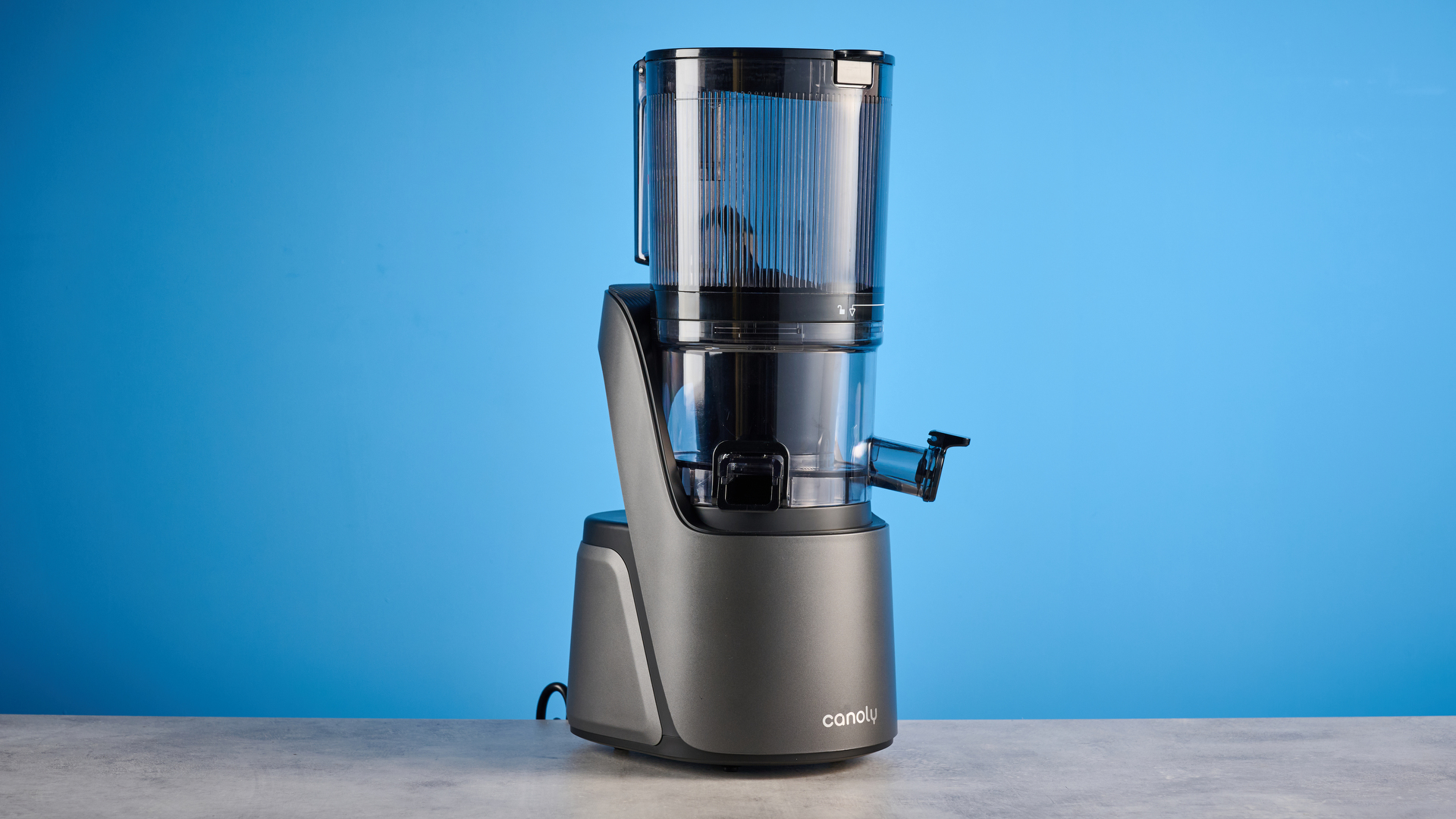 Canoly C16 Cold Press Juicer photographed in front of a blue background