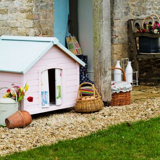 pink pet kennel in cottage garden