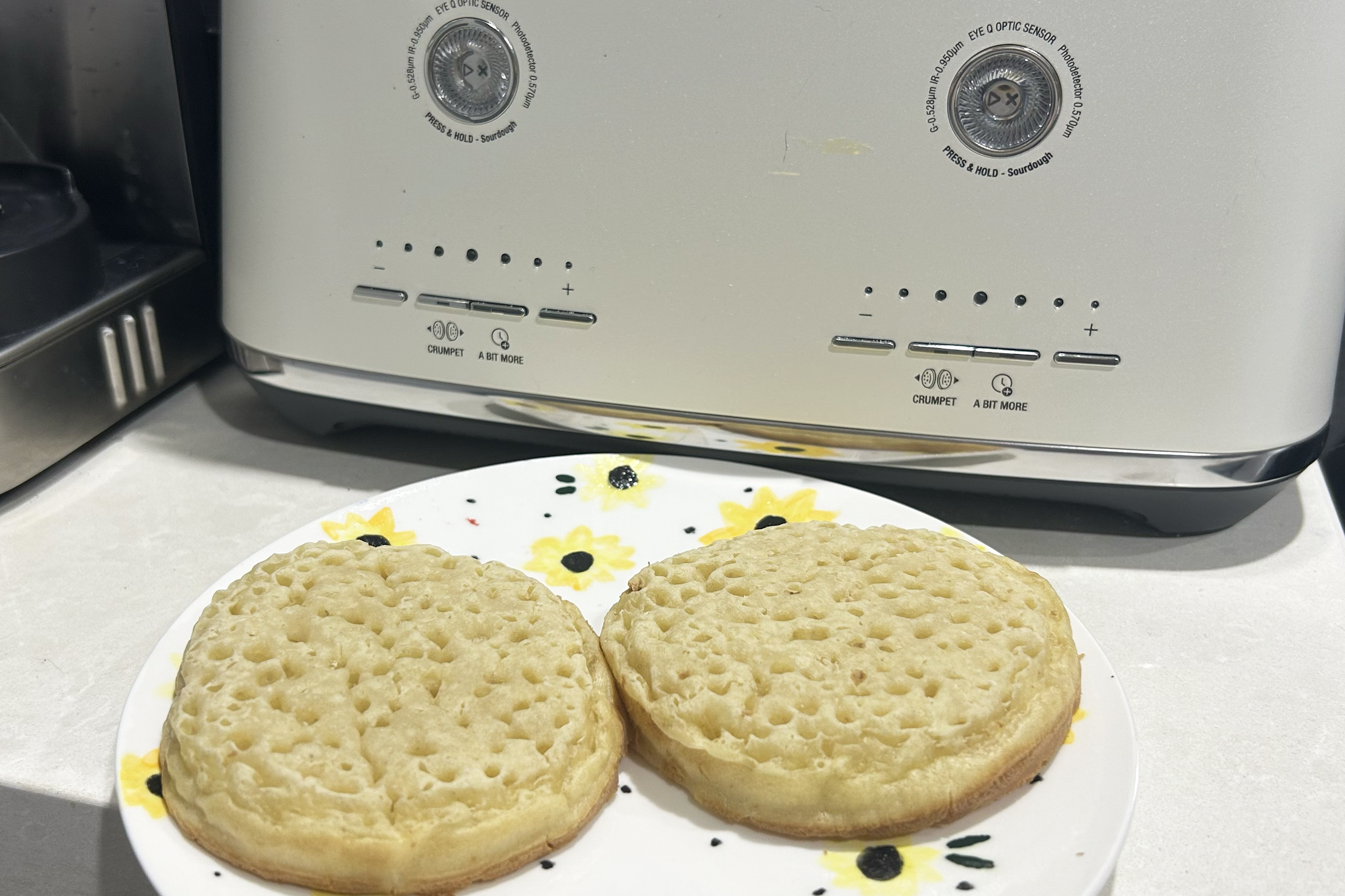 Crumpets on sunflower plate with white Breville toaster in background