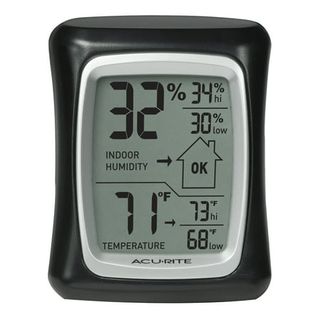 A small rectangular hydrometer andthermometer for home . Black framed, digital display