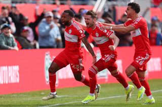 Chicago Fire's Kellyn Acosta celebrates with his team-mates after scoring a late winner against Montreal in March 2024.