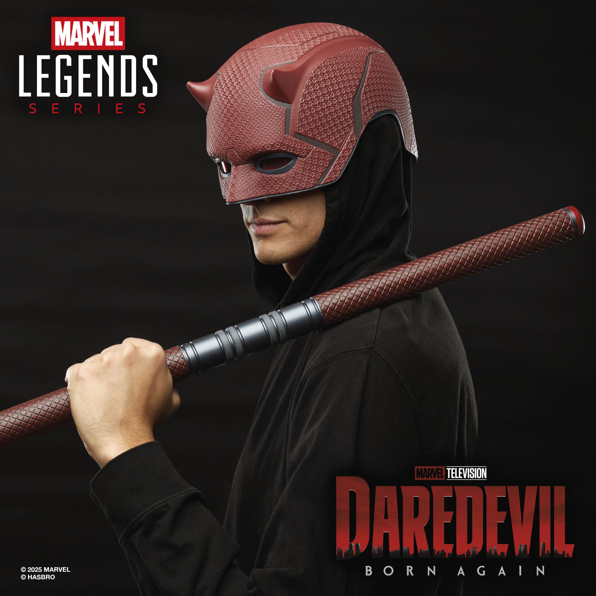 A man looks back while wearing a Marvel Legends Series Daredevil replica helmet and holding a Billy Club against a dark background with a city-scape pattern, alongside the Marvel Legends Series and Daredevil: Born Again logos