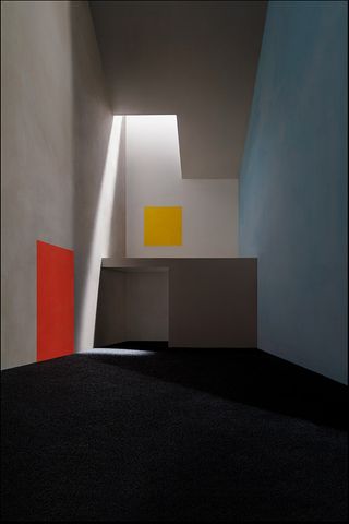 A vestibule with orange panel and yellow panel painted on wall