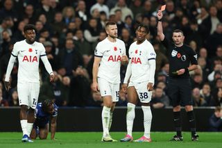 Destiny Udogie of Tottenham Hotspur looks dejected after being shown a red card by Referee Michael Oliver during the Premier League match between Tottenham Hotspur and Chelsea FC at Tottenham Hotspur Stadium on November 06, 2023 in London, England.