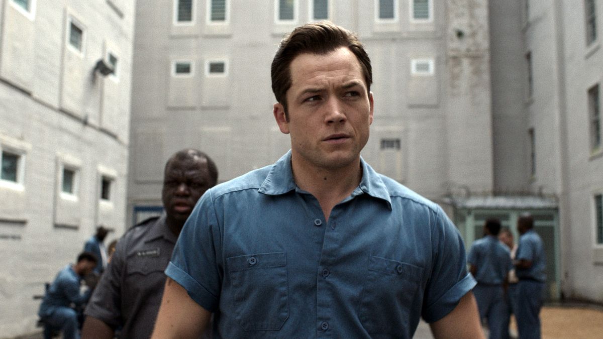 Taron Egerton as Jimmy Keene, walking in a prison, in Black Bird