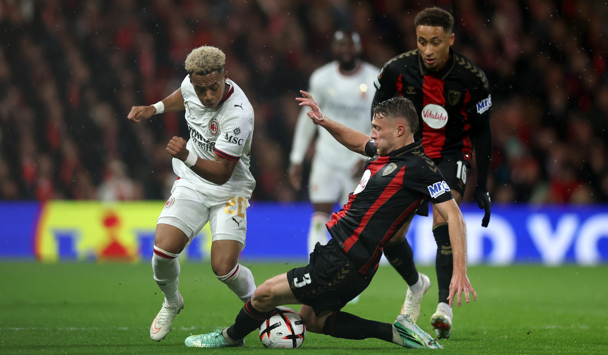 Omari Hutchinson of AC Milan is tackled by Adrien Truffert of Bournemouth during the UEFA Europa League 2026/27 League Phase match at Bournemouth Stadium on October 22, 2026 in Bournemouth, England