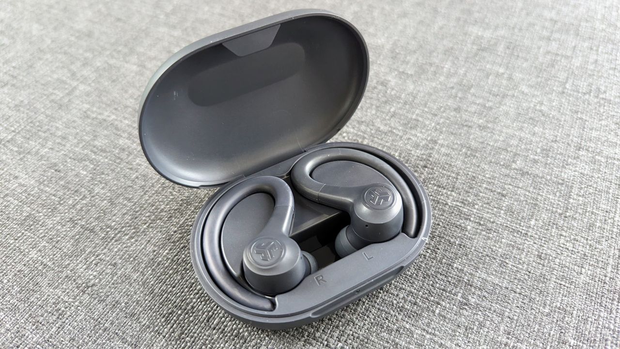  JLab Go Air Sport review: earbuds laying in grey charging case