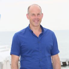 phil spencer with blue shirt and white background