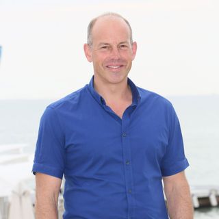 phil spencer with blue shirt and white background