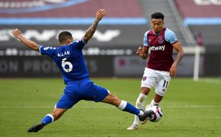 Jesse Lingard, right, is tackled by Everton's Allan