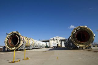 Two spent shuttle solid rocket boosters await inspection and cleaning near Hangar AF at Cape Canaveral Air Force Station in Florida. The boosters were used during space shuttle Discovery's STS-133 launch from NASA Kennedy Space Center's Launch Pad 39A on