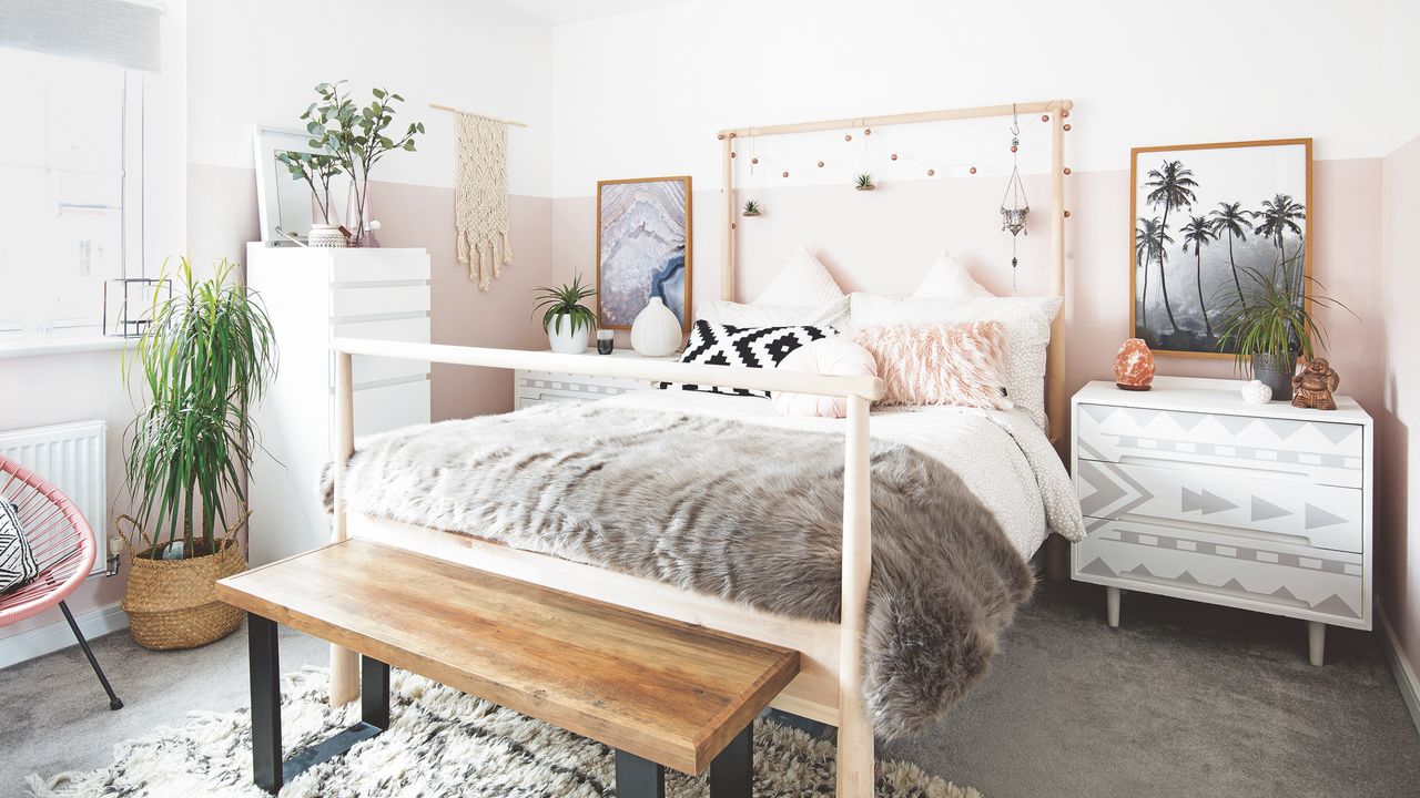 bedroom paint ideas, bedroom with 2 thirds pink painted wall, white on the top third, pale wood bed, sheepskin throw on bed, macramé on wall, grey carpet, basket, artwork