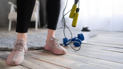 person holding a skipping rope in their living room