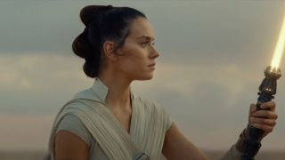 Daisy Ridley's Rey holding yellow lightsaber in Star Wars: The Rise of Skywalker