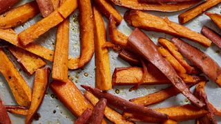 Tray of baked sweet potato fries fresh out of the oven