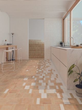 A kitchen with a mixture of pink and white gloss and matte tiles on the floor