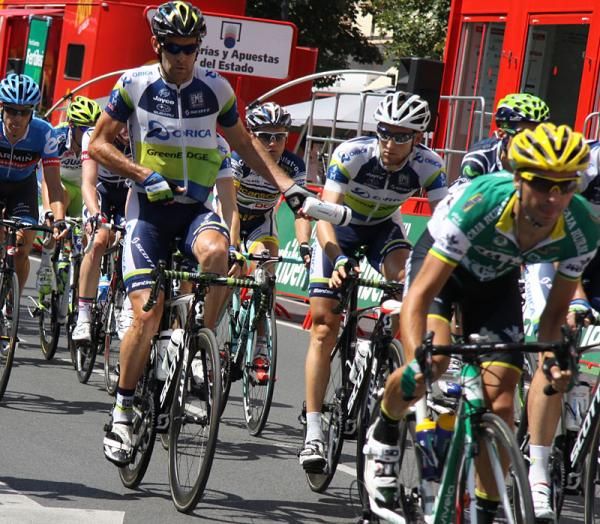 Orica GreenEdge riders hand off botttles.