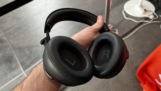 Shure AONIC 50 Gen 2 headphones held in a man's hand