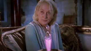 Meryl Streep grimaces in front of a glowing pink vial in Death Becomes Her.