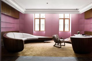 Chinese styled suite with curved furniture and purple painted walls