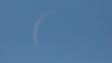 An image of the moon and Venus in a blue sky.