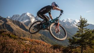 A rider on the Yeti SB160 doing an air in the mountains
