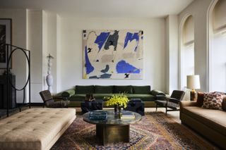 A living room with a large piece of wall art