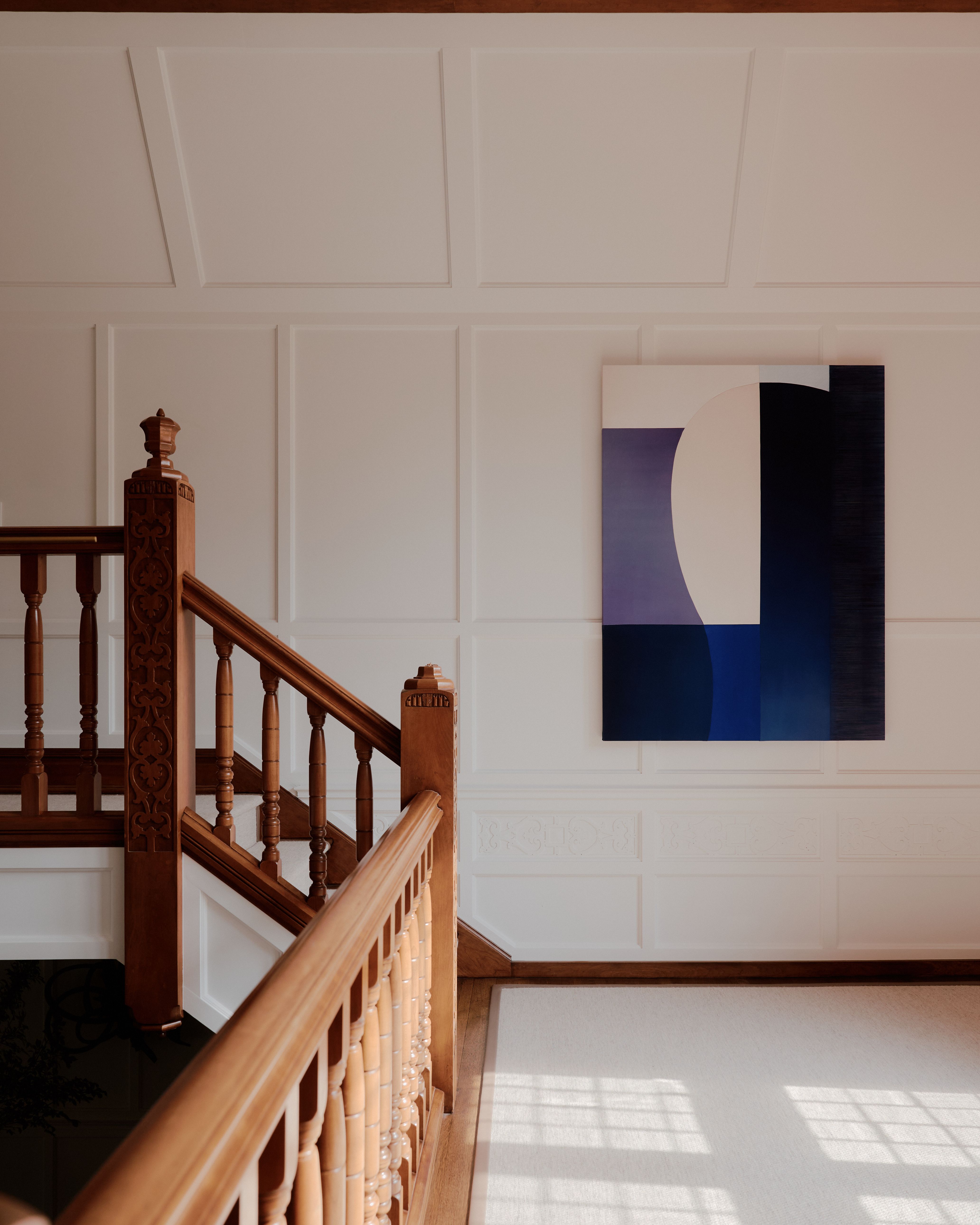 Sun-lit interior of a palatial residence wooden windows, white-washed walls, and artful decor.